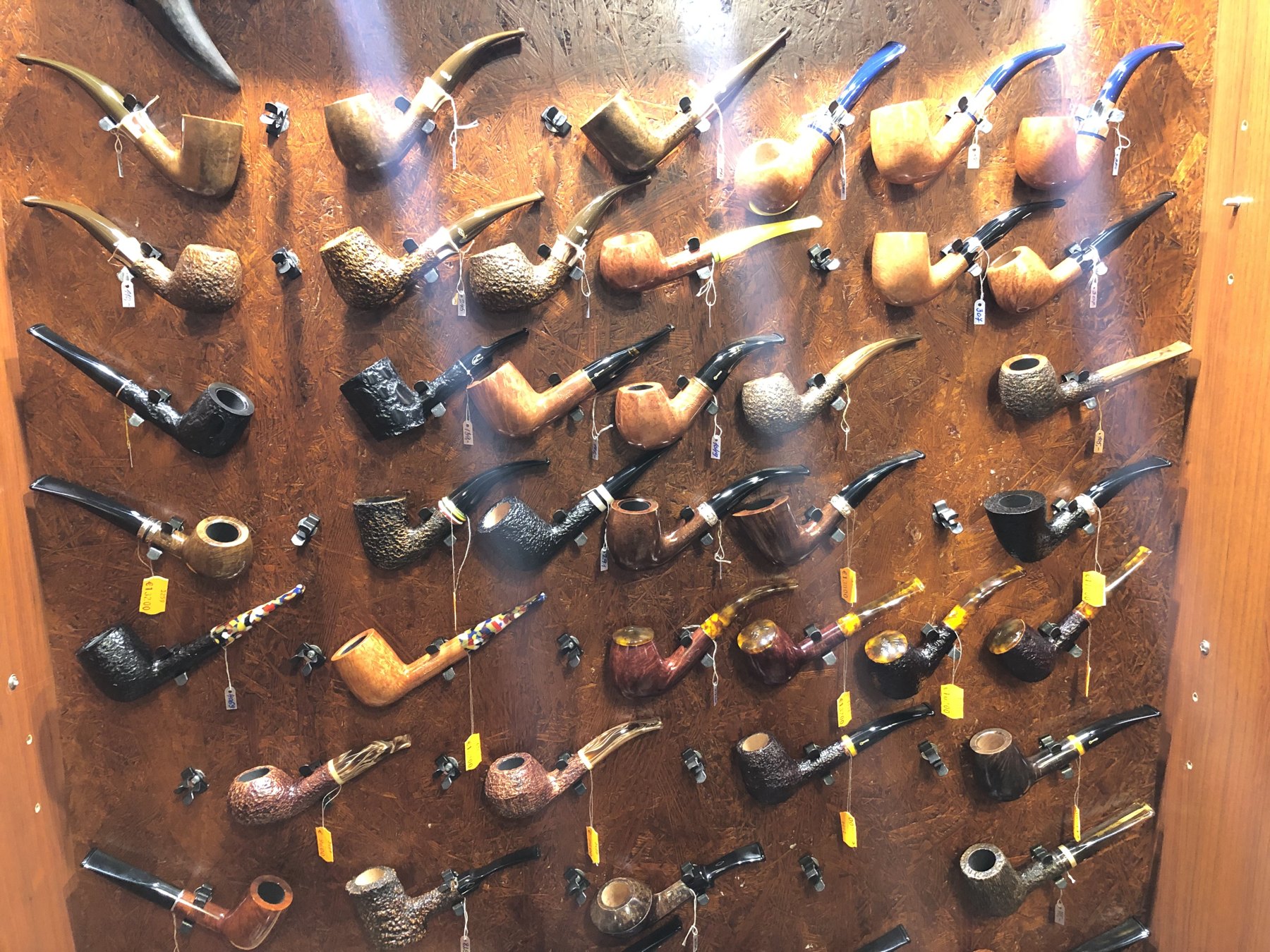 A wall of briar pipes on display inside Alberta Pīpes